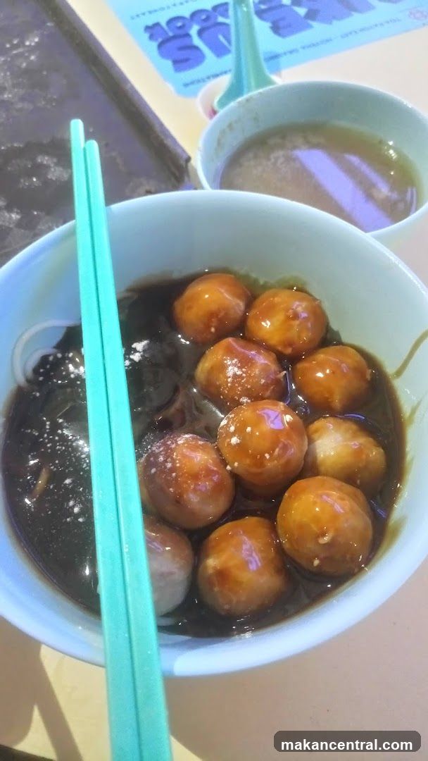 Meatballs in dark sauce with noodles
