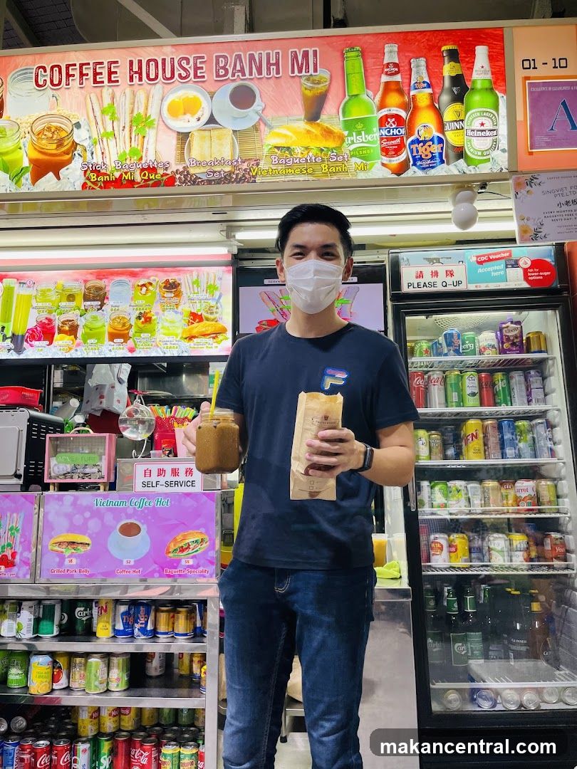 Man Holding Coffee and Baguette