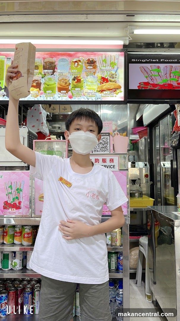 Boy Holding a Baguette