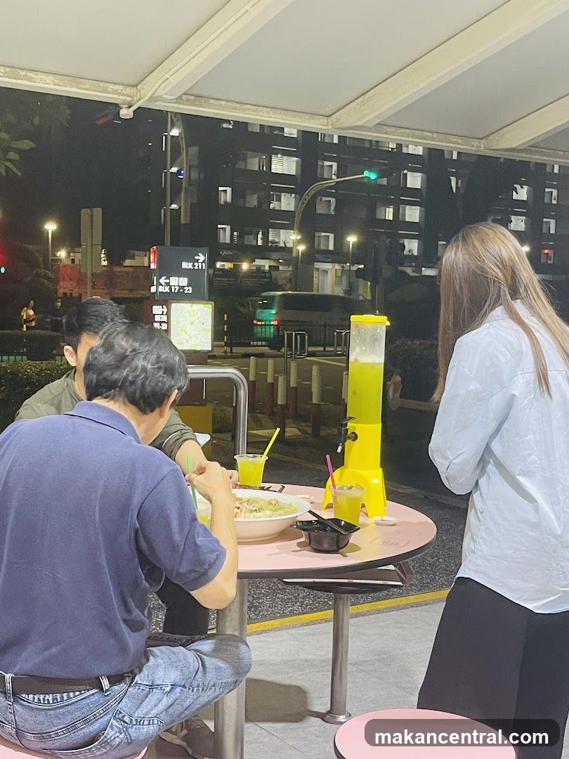 People eating at a table with a drink dispenser