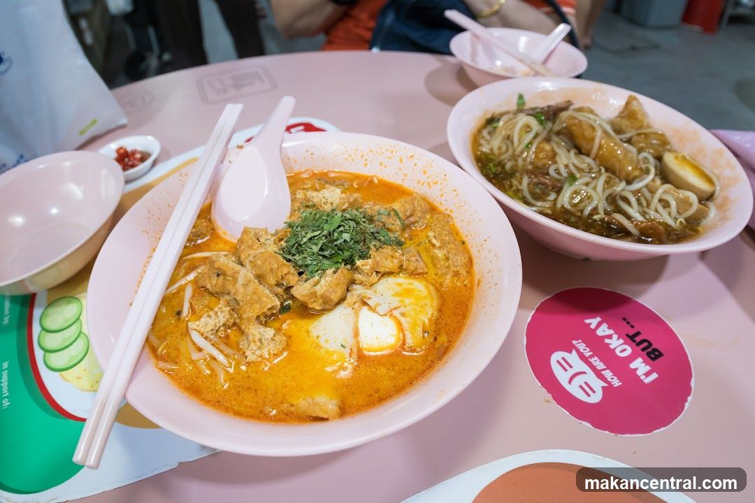 Two bowls of noodles on a pink table