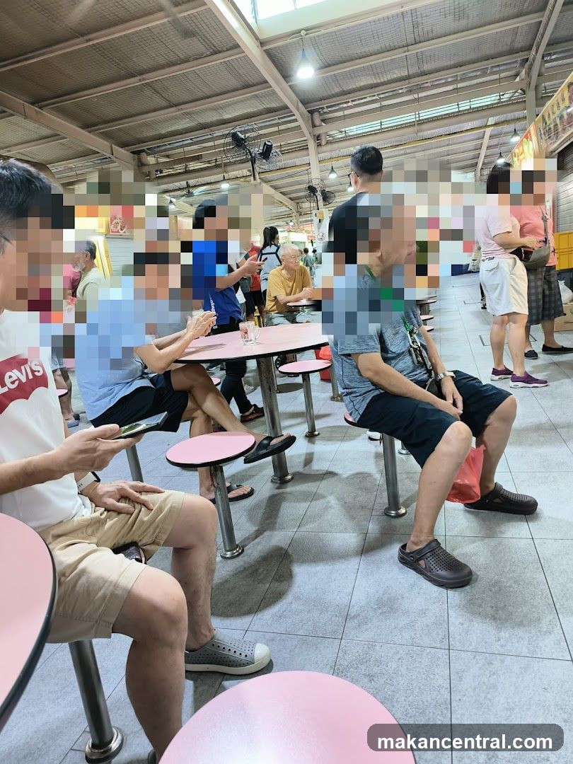 People sitting at tables in a food court