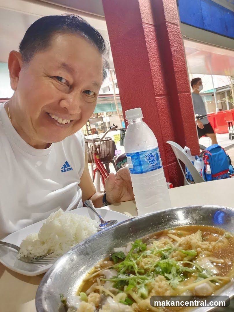 Man Eating Steamed Fish with Rice