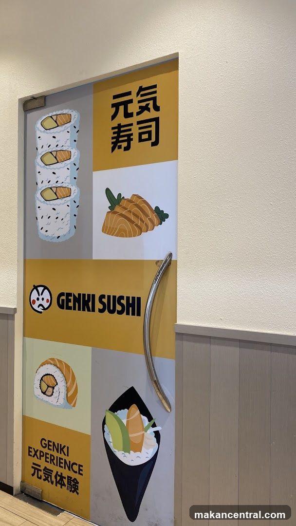 The image shows a closed door decorated with colorful illustrations of sushi and the Genki Sushi logo. The door is divided into sections, with images of sushi rolls, sashimi, and a hand roll. The Genki Sushi logo, featuring a cartoon face and the text "GENKI SUSHI" in English and Japanese, is prominently displayed. The door has a silver handle and is set against a light-colored wall.