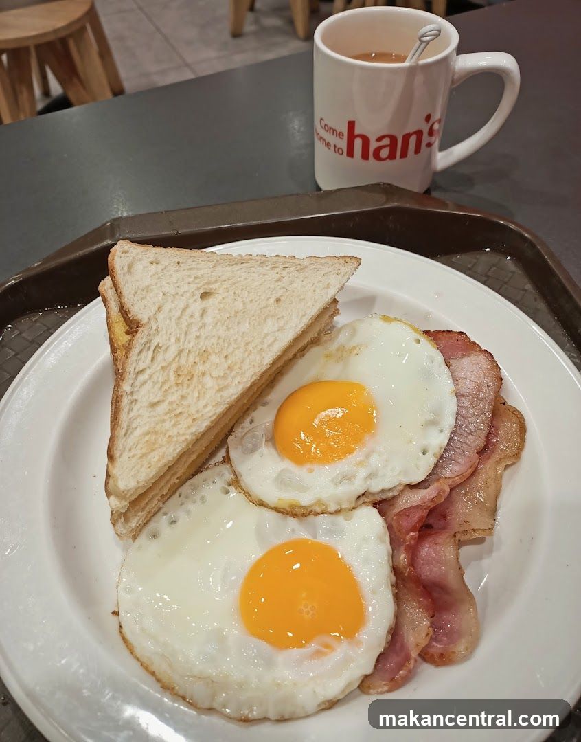 Breakfast Plate with Fried Eggs, Bacon, and Toast