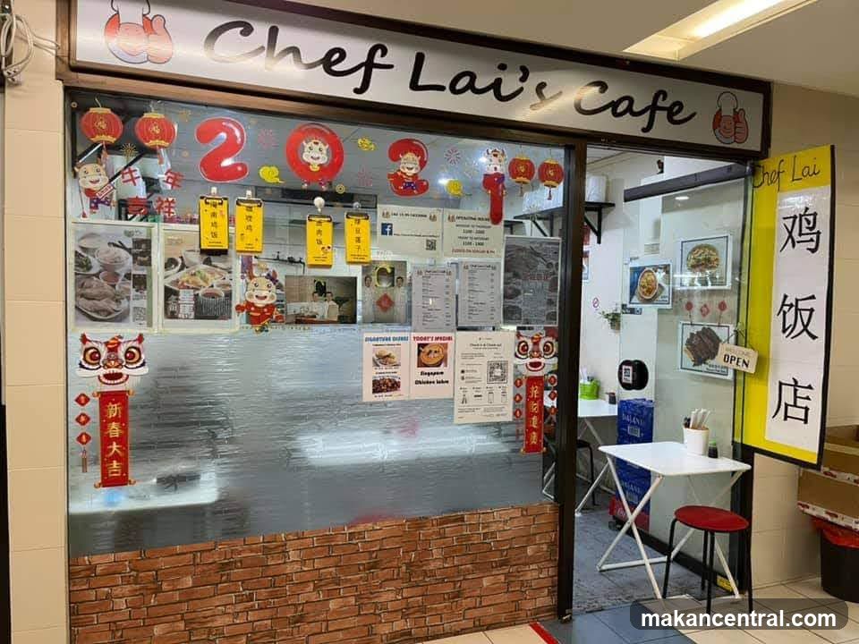 The exterior of Chef Lai's Cafe features a large glass window displaying various decorations and menus. A prominent sign above the window reads "Chef Lai's Cafe". Inside, tables and chairs are visible, along with framed pictures of food. A vertical yellow sign with Chinese characters is placed to the right of the entrance.