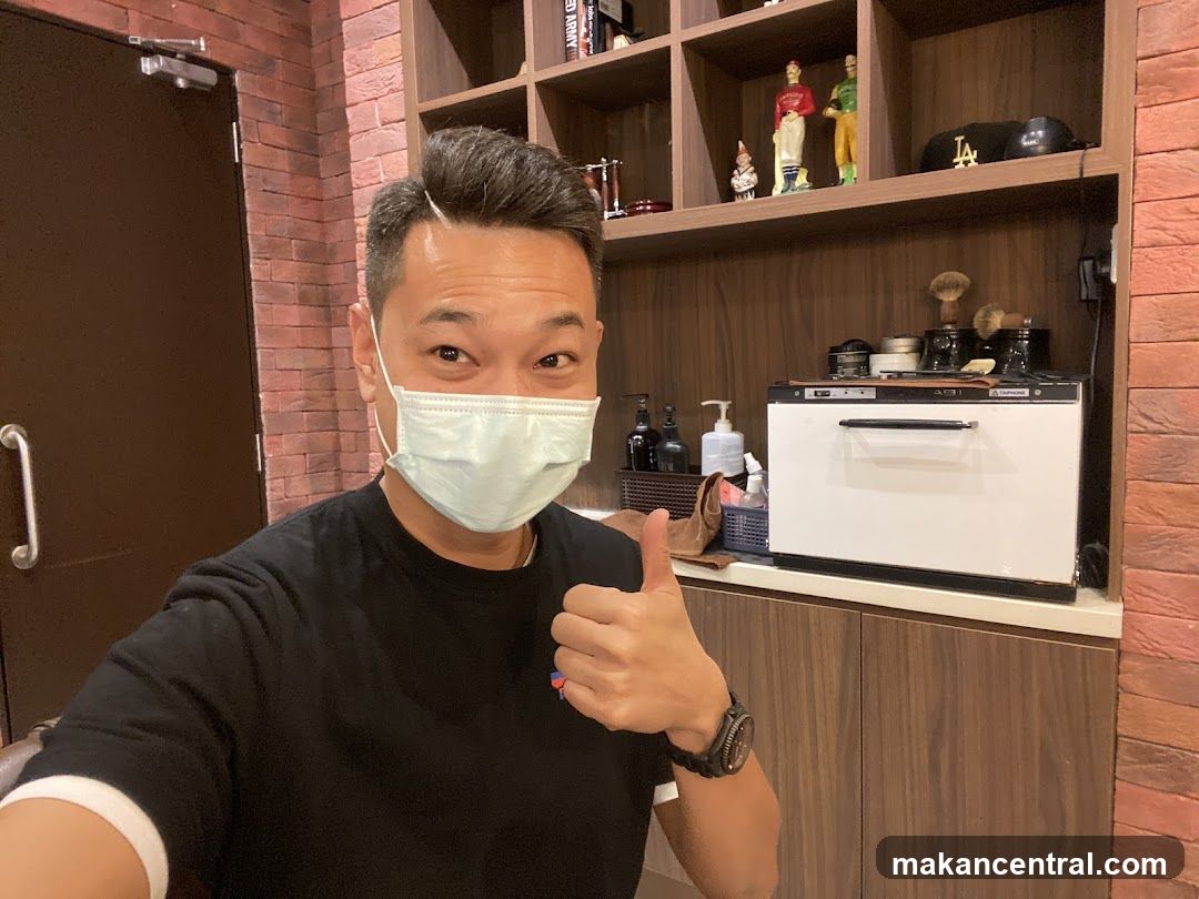 Man giving a thumbs up in a barbershop