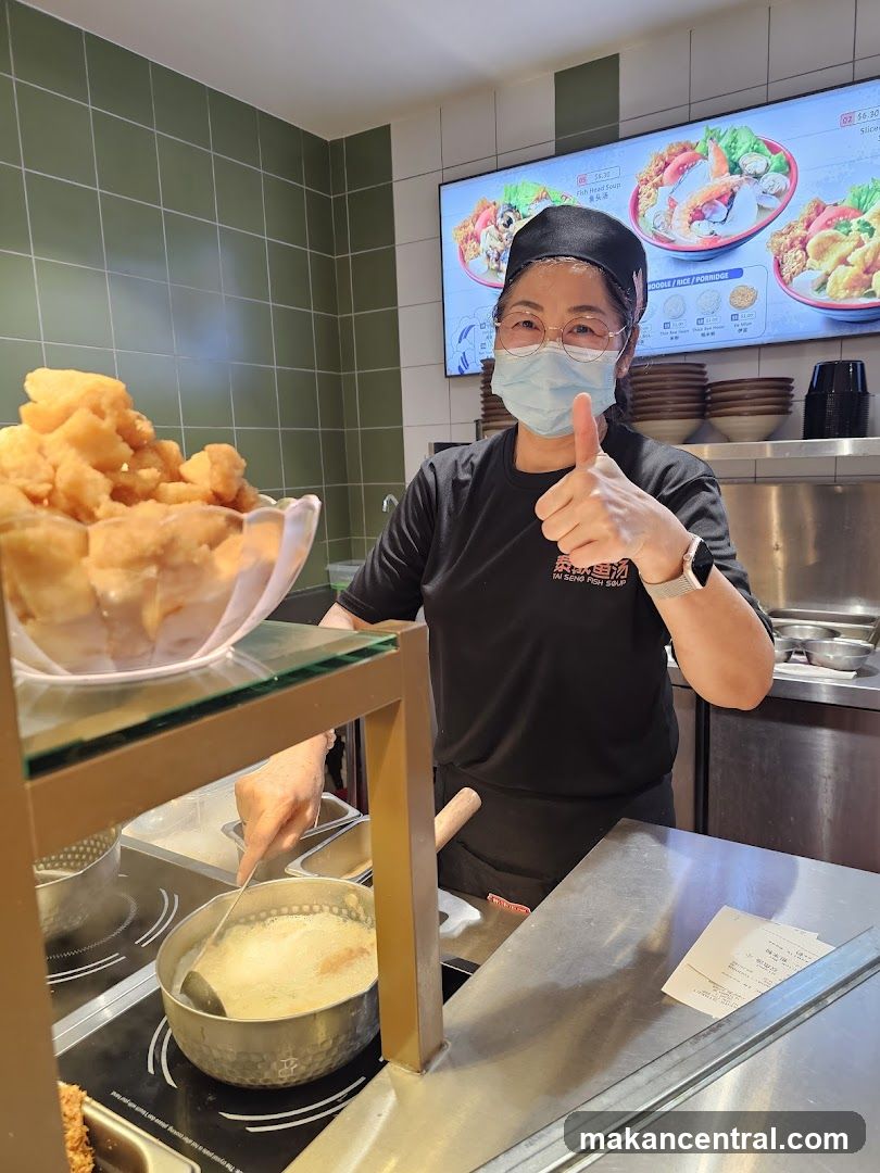 Food stall worker giving a thumbs up