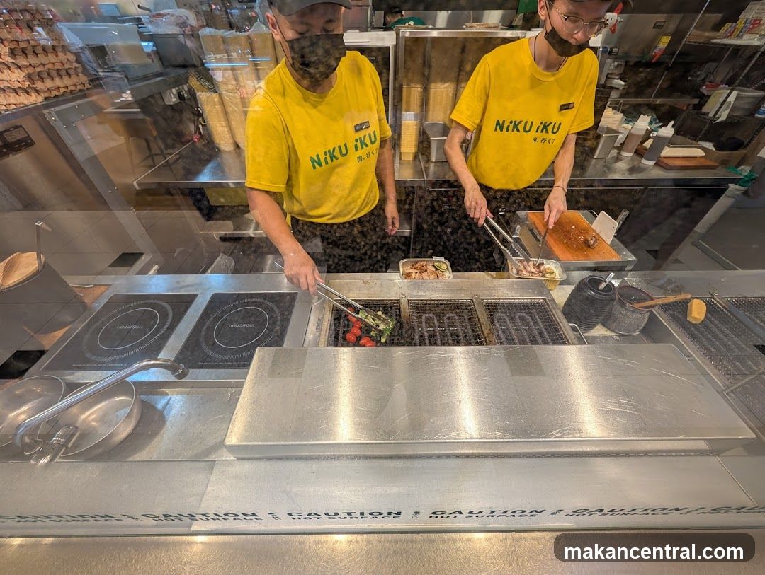 Chefs cooking at a grill