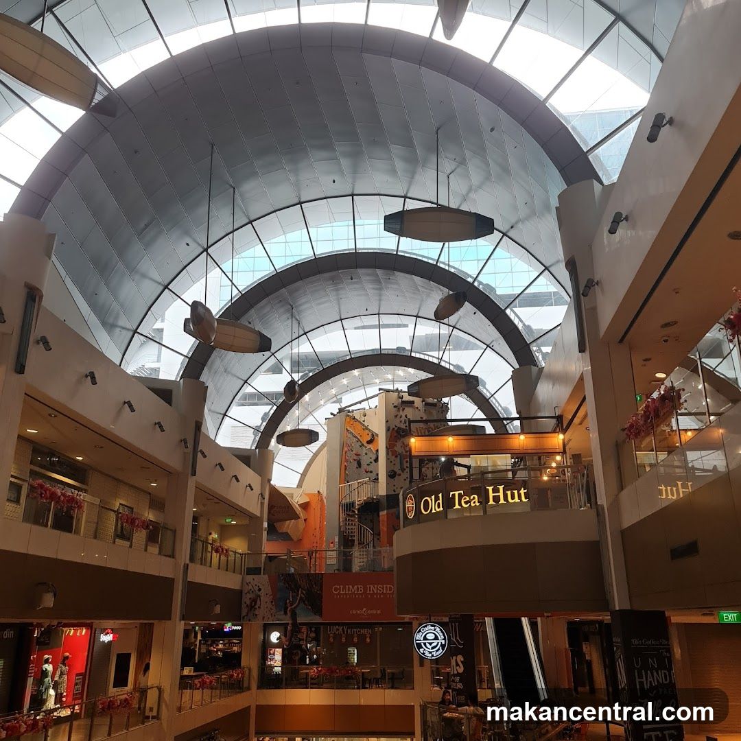 Indoor mall atrium with climbing wall and shops