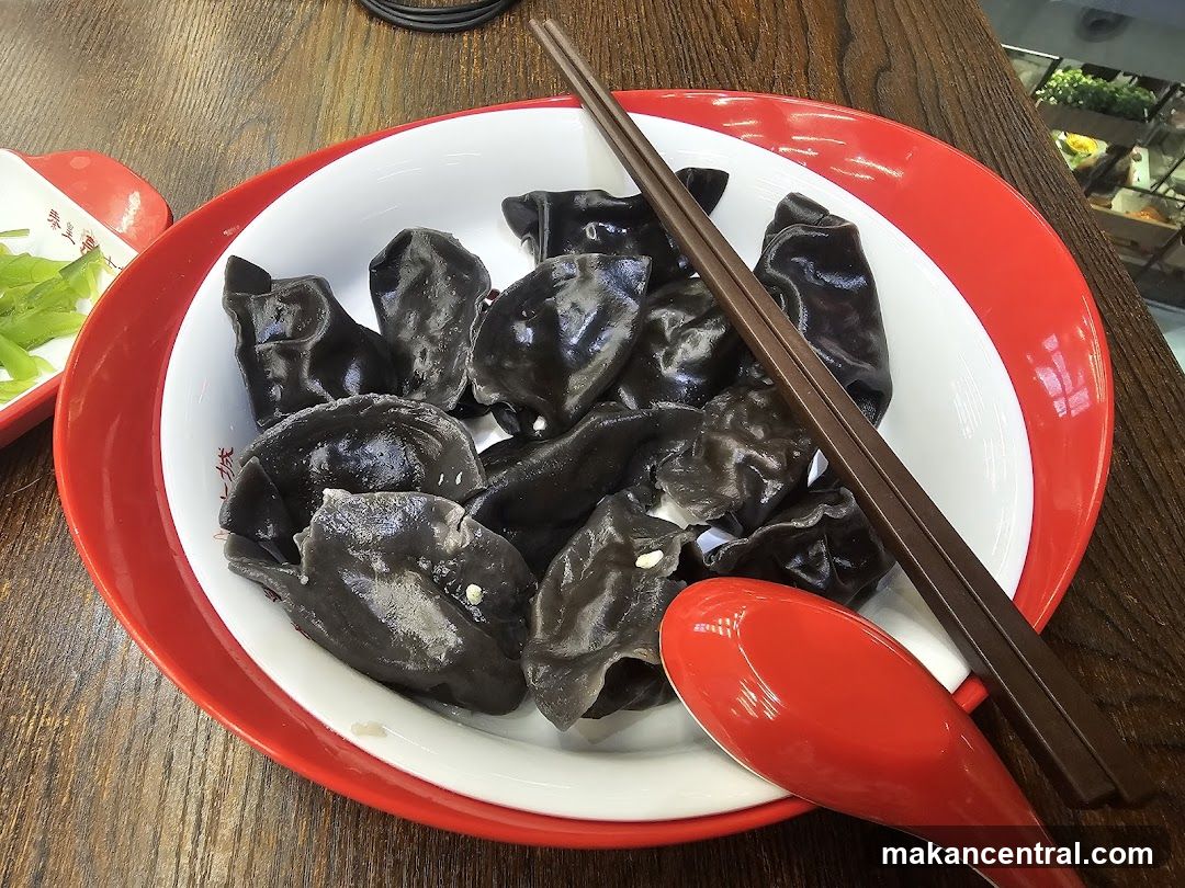 Black Dumplings with Chopsticks and Spoon