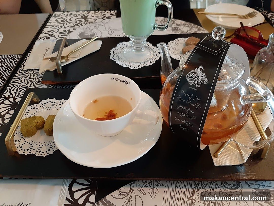 Tea set with cookies and a green drink