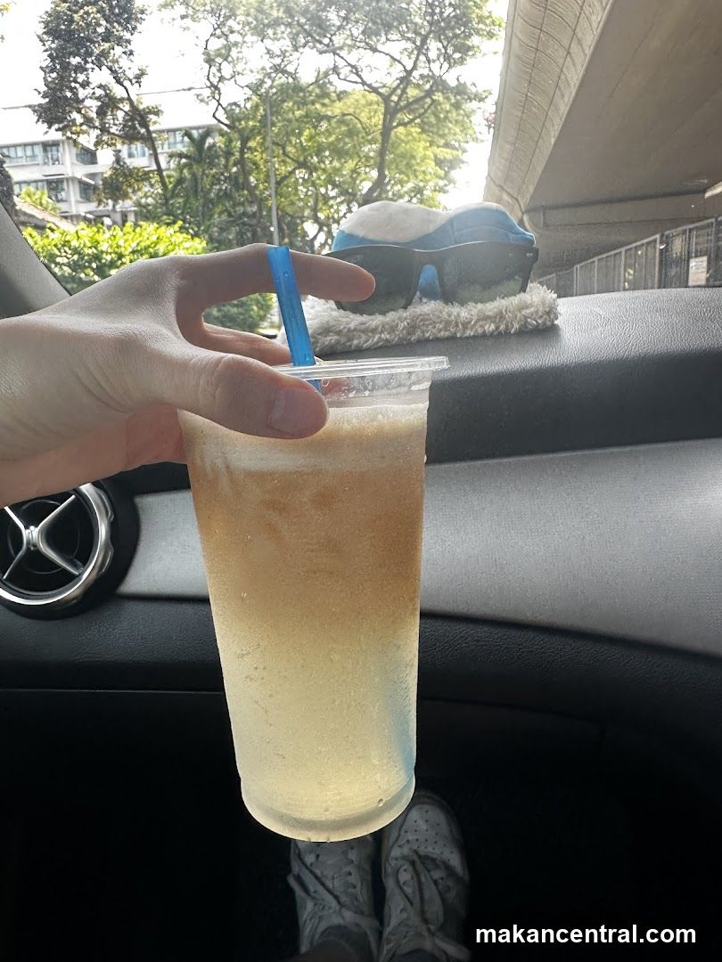 Hand holding a drink in a car