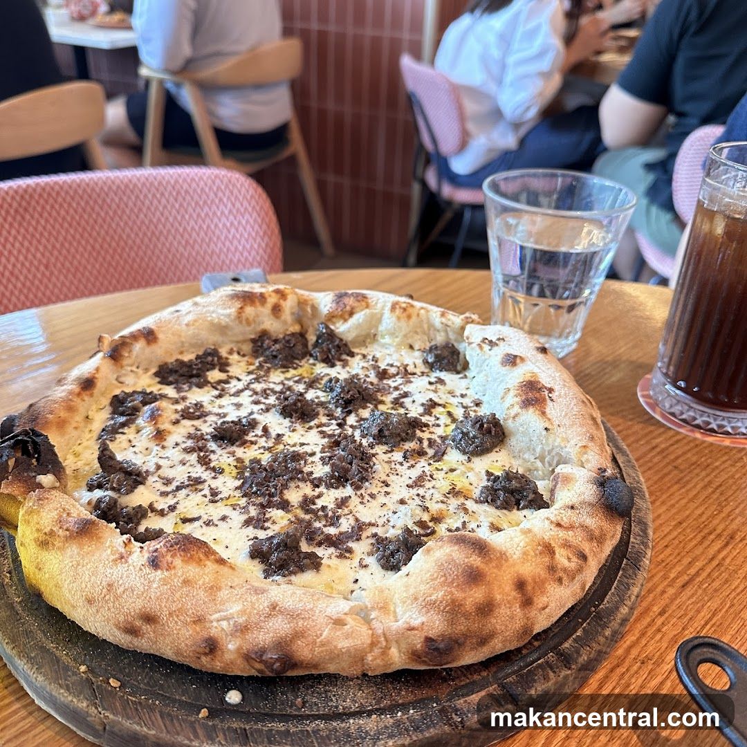 Pizza with white sauce and dark toppings