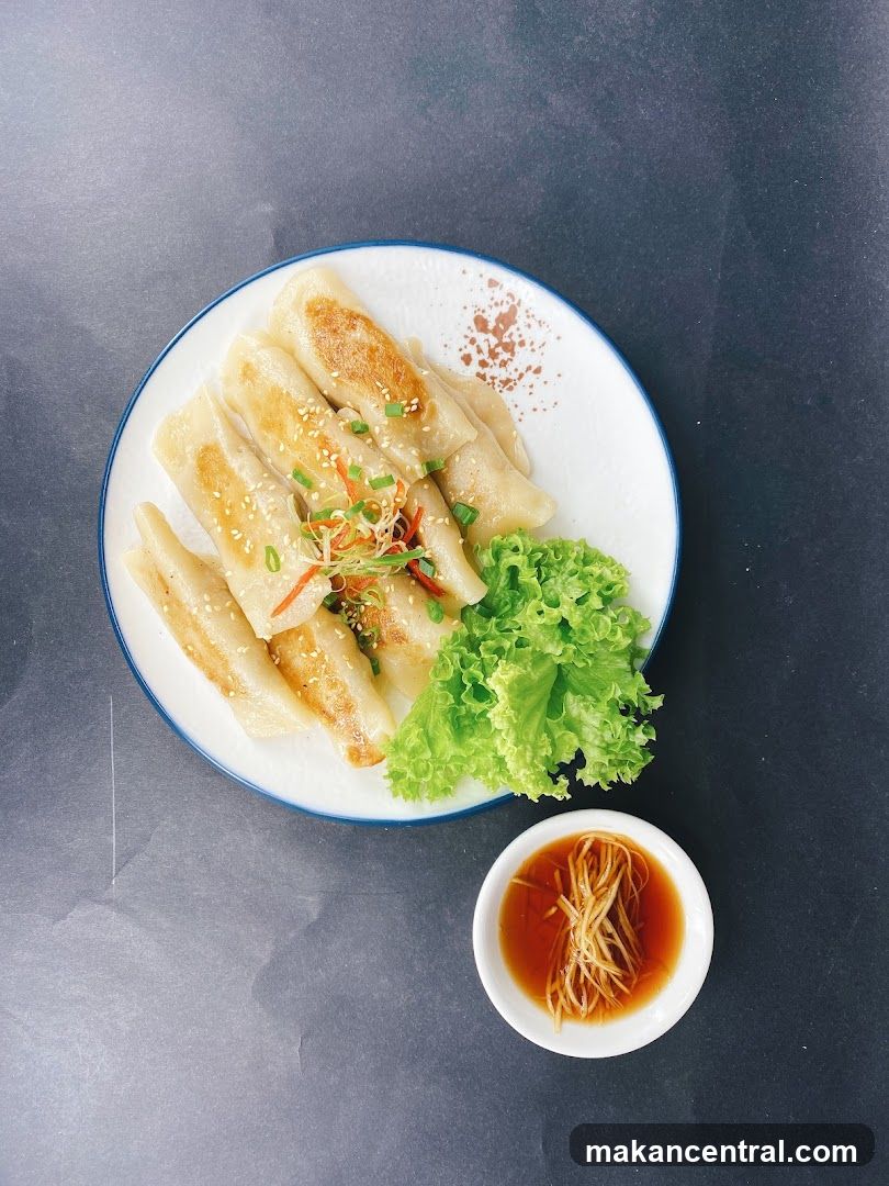 Pan-fried dumplings with dipping sauce