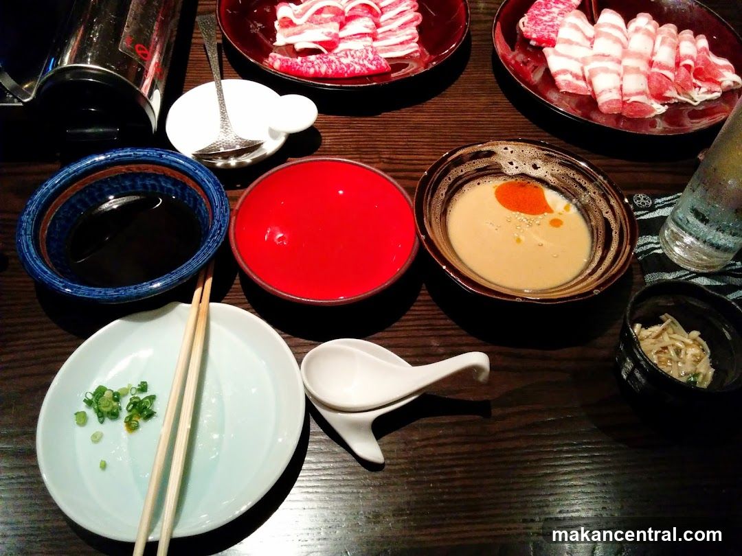 Table Setting with Raw Meats and Sauces