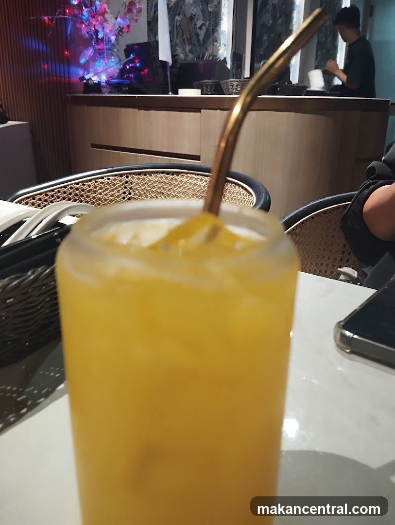 Orange Drink with Gold Straw