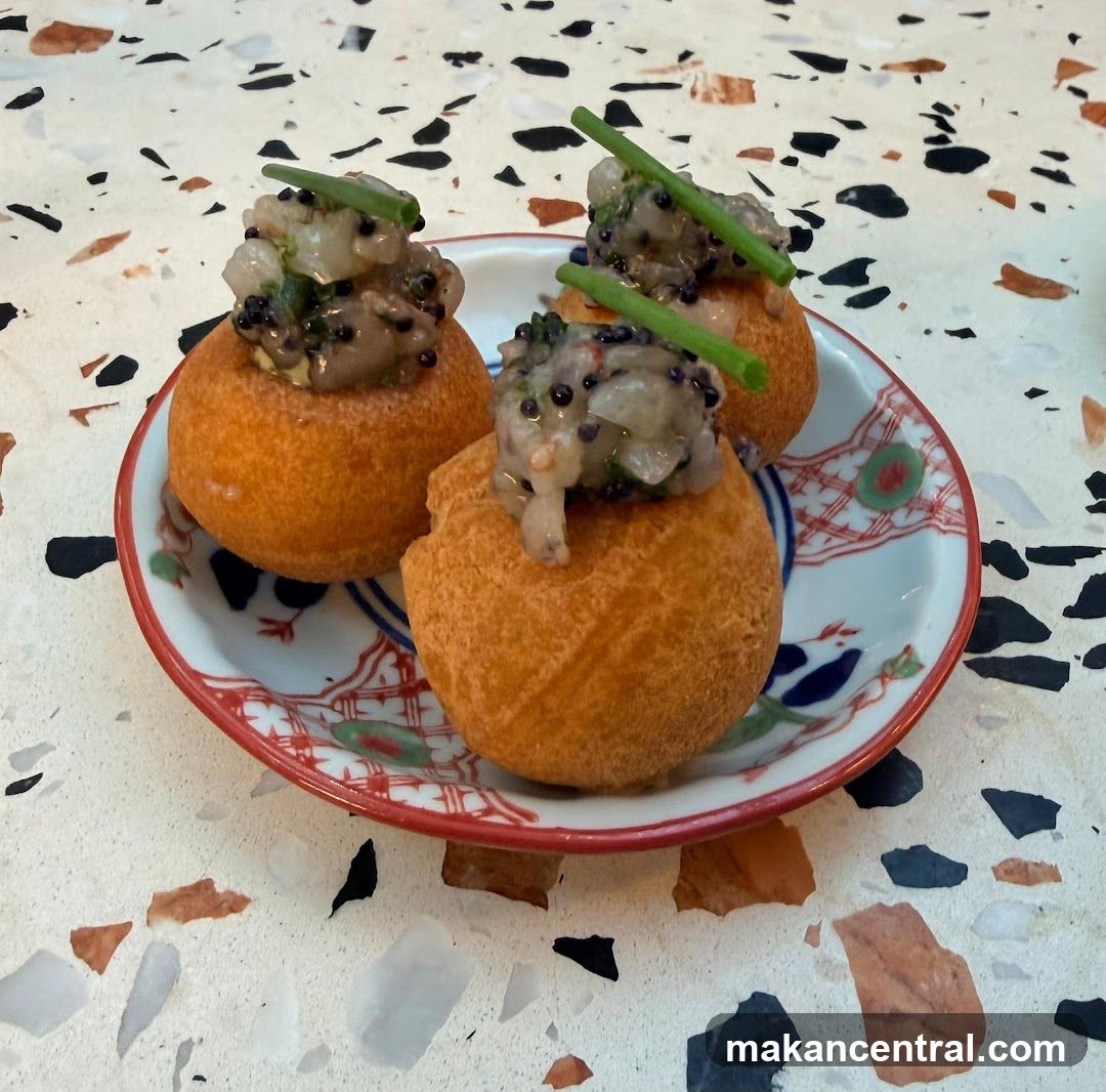 Three savory bites on a decorative plate