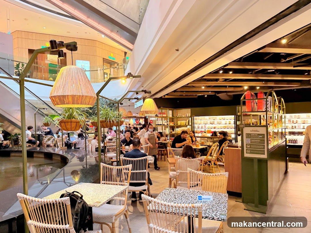 Indoor cafe with seating and shelves of products