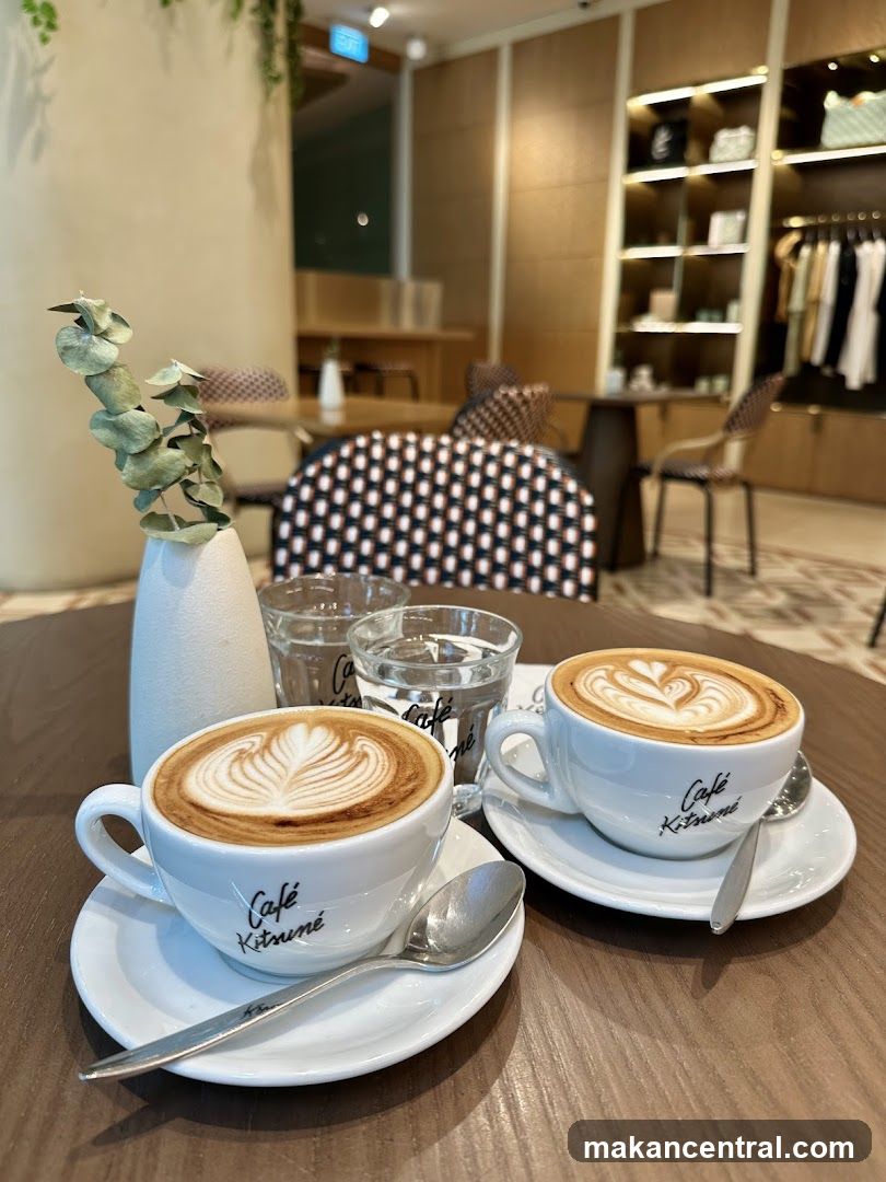 Two lattes with latte art on a table