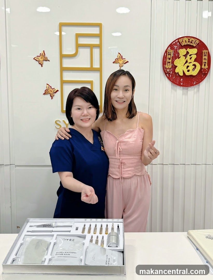 Two women posing with a beauty product set