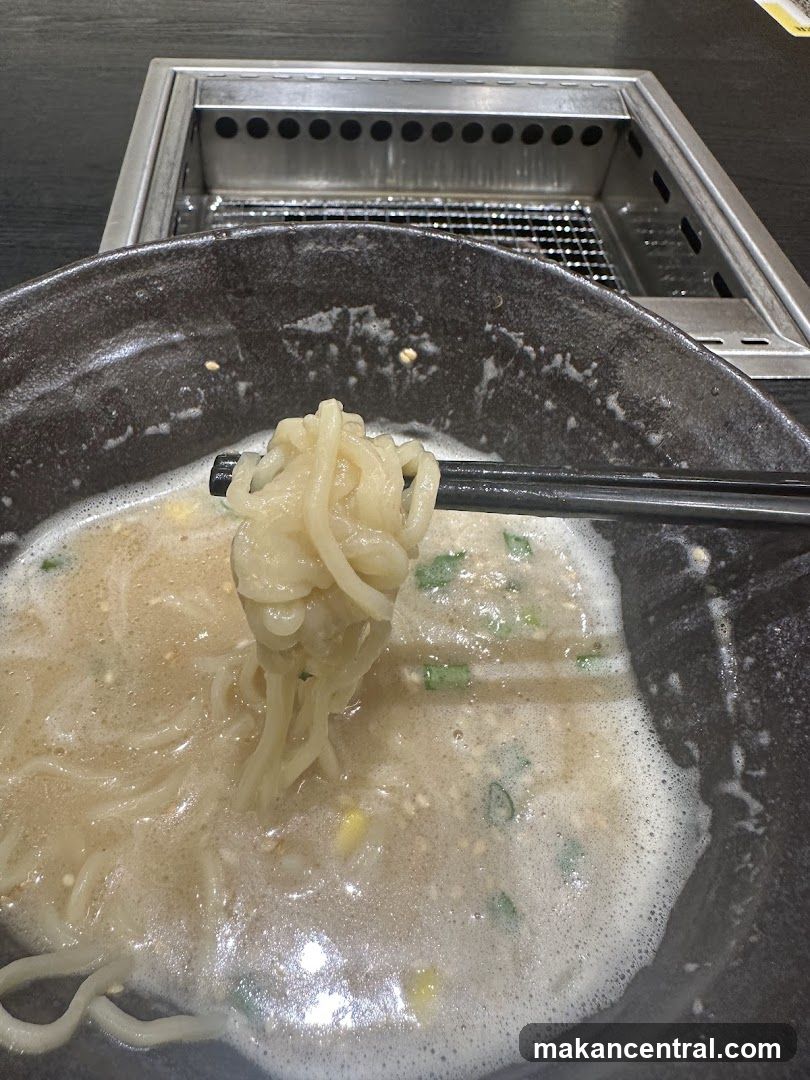 Ramen being lifted with chopsticks