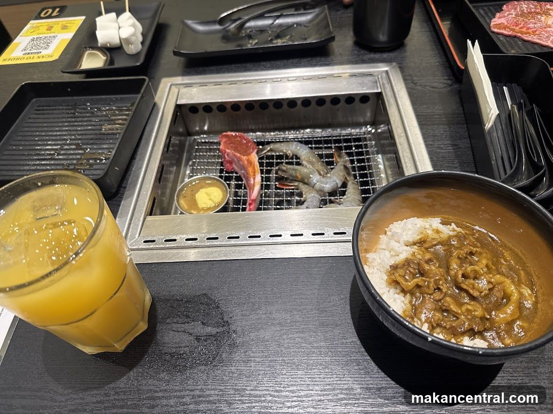 Table setting with grilled food and curry rice