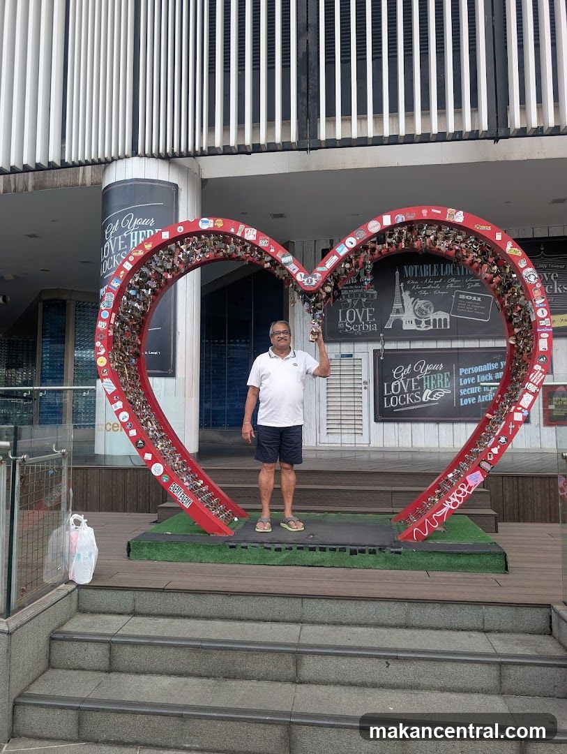 Man Posing with Heart-Shaped Lock Display