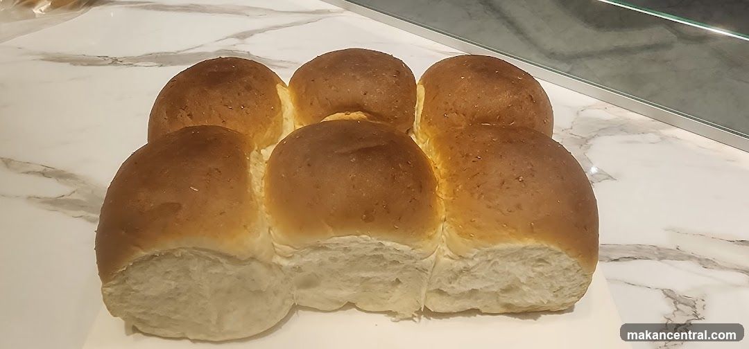 Six golden brown dinner rolls