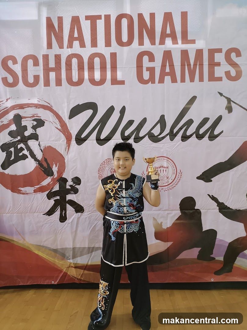 Young Wushu Athlete with Trophy