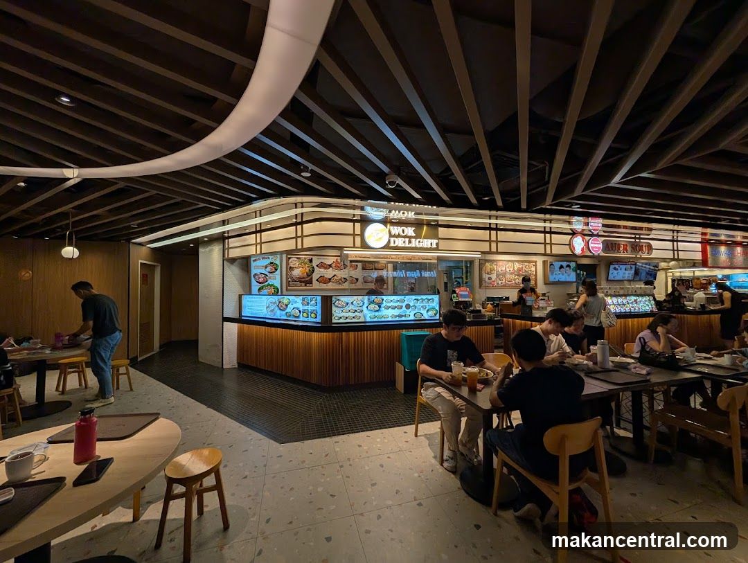Food court with multiple stalls and diners