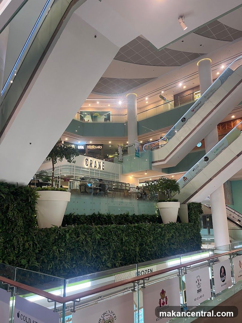 Interior of a shopping mall with escalators and storefronts