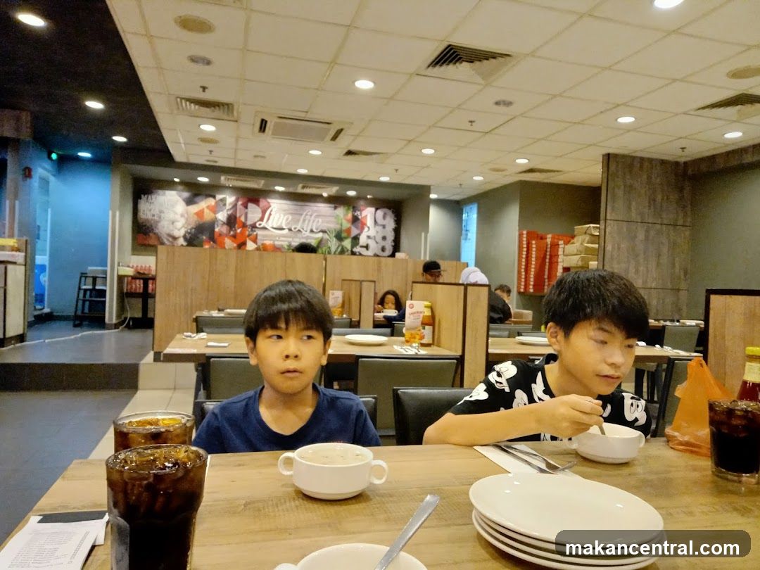 Two boys eating at a restaurant