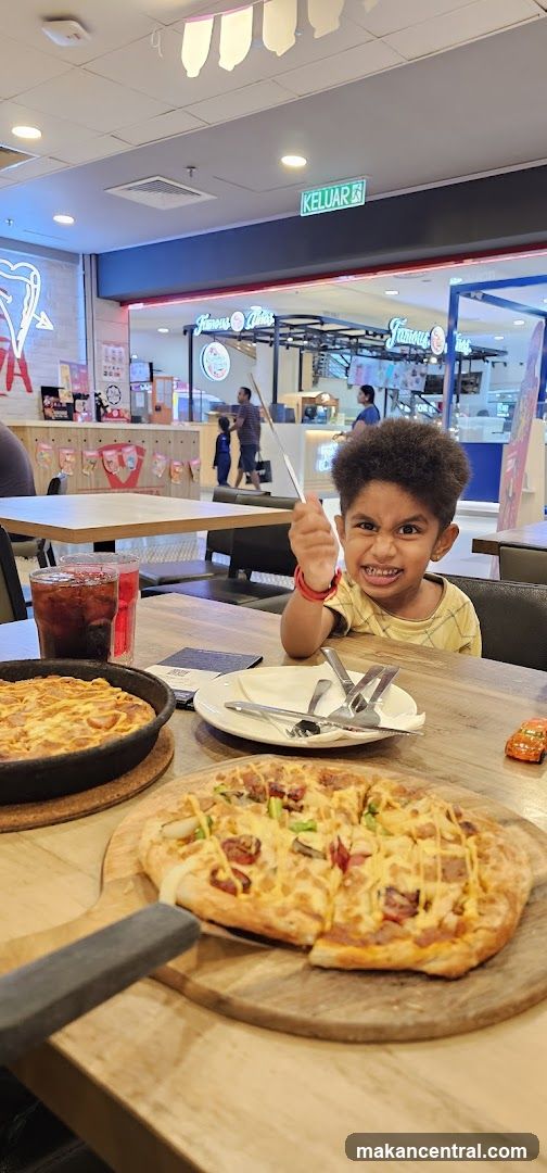 Pizzas and a Child at a Restaurant