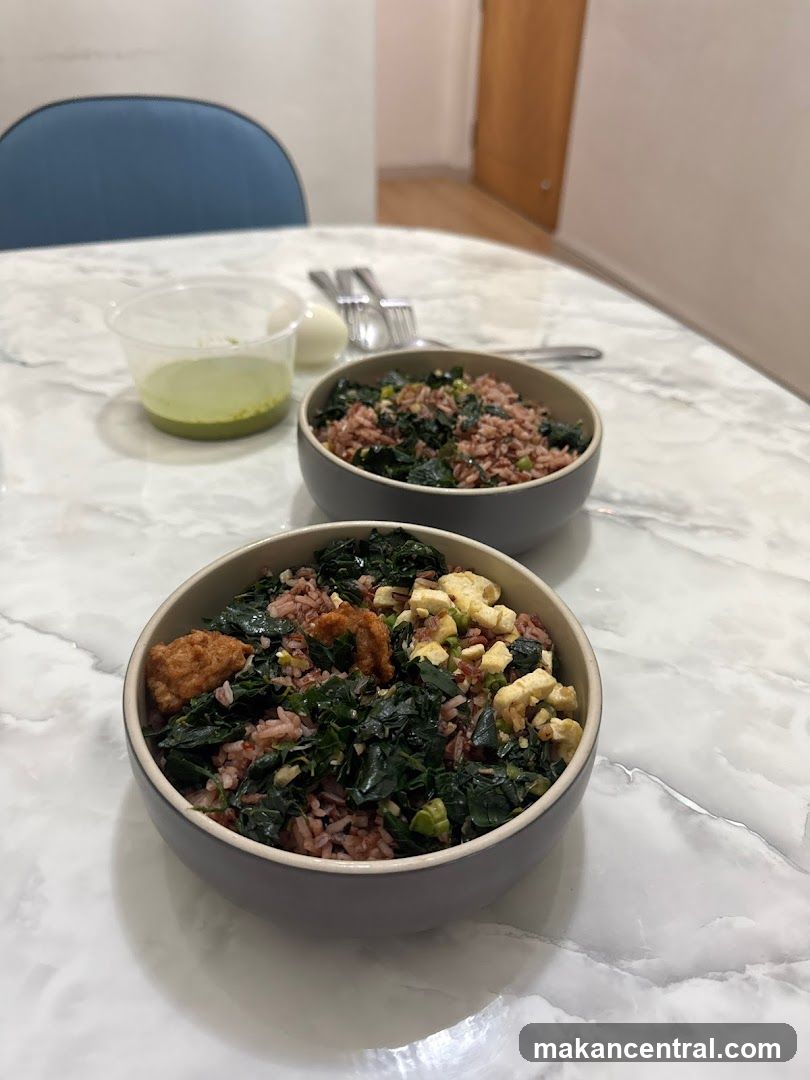 Two bowls of rice with greens and toppings