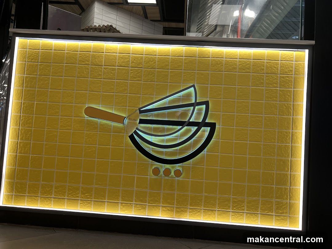 Yellow tiled wall with a logo