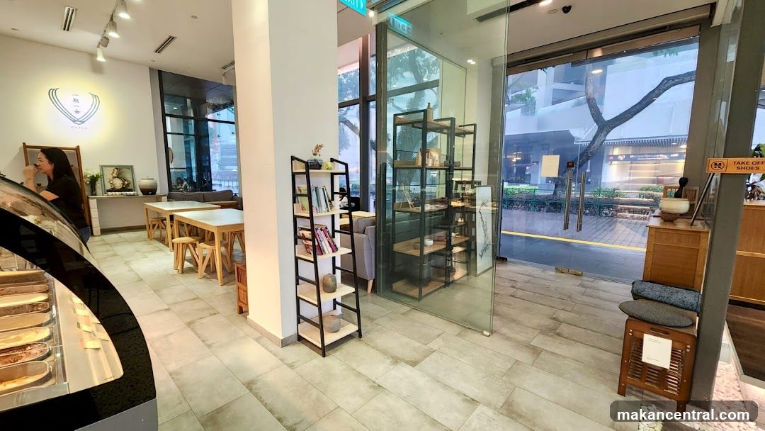 Interior of a cafe with seating and display shelves