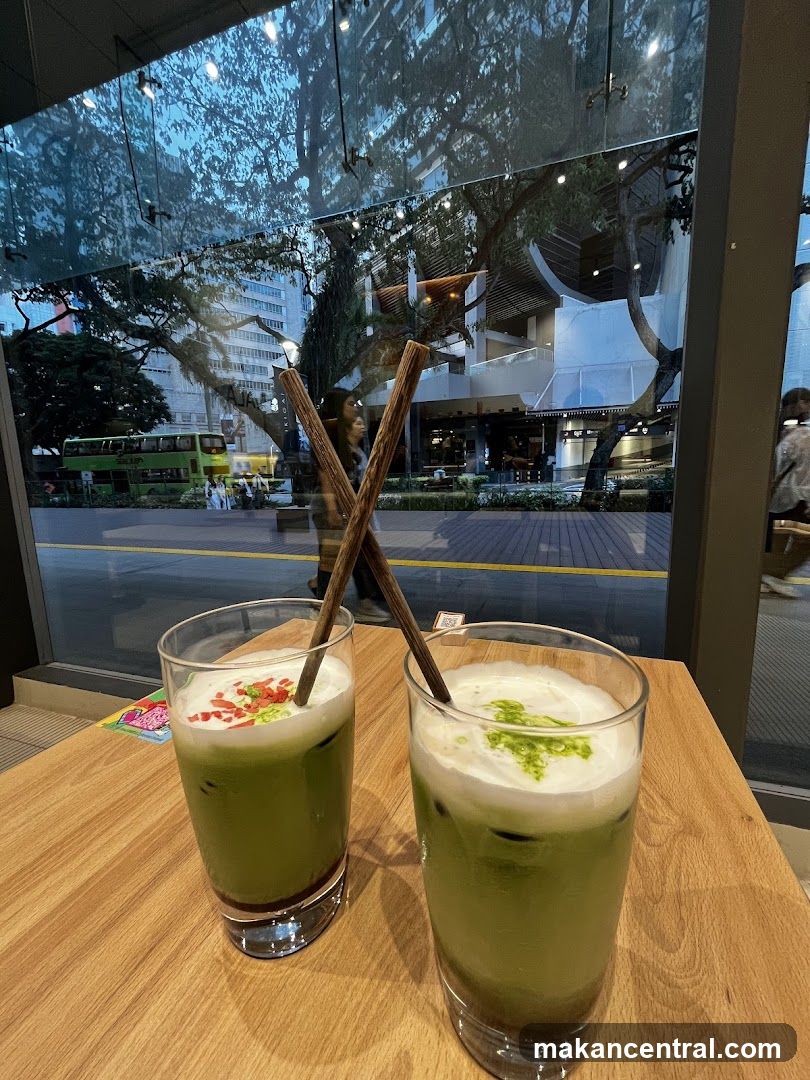 Two matcha drinks on a wooden table
