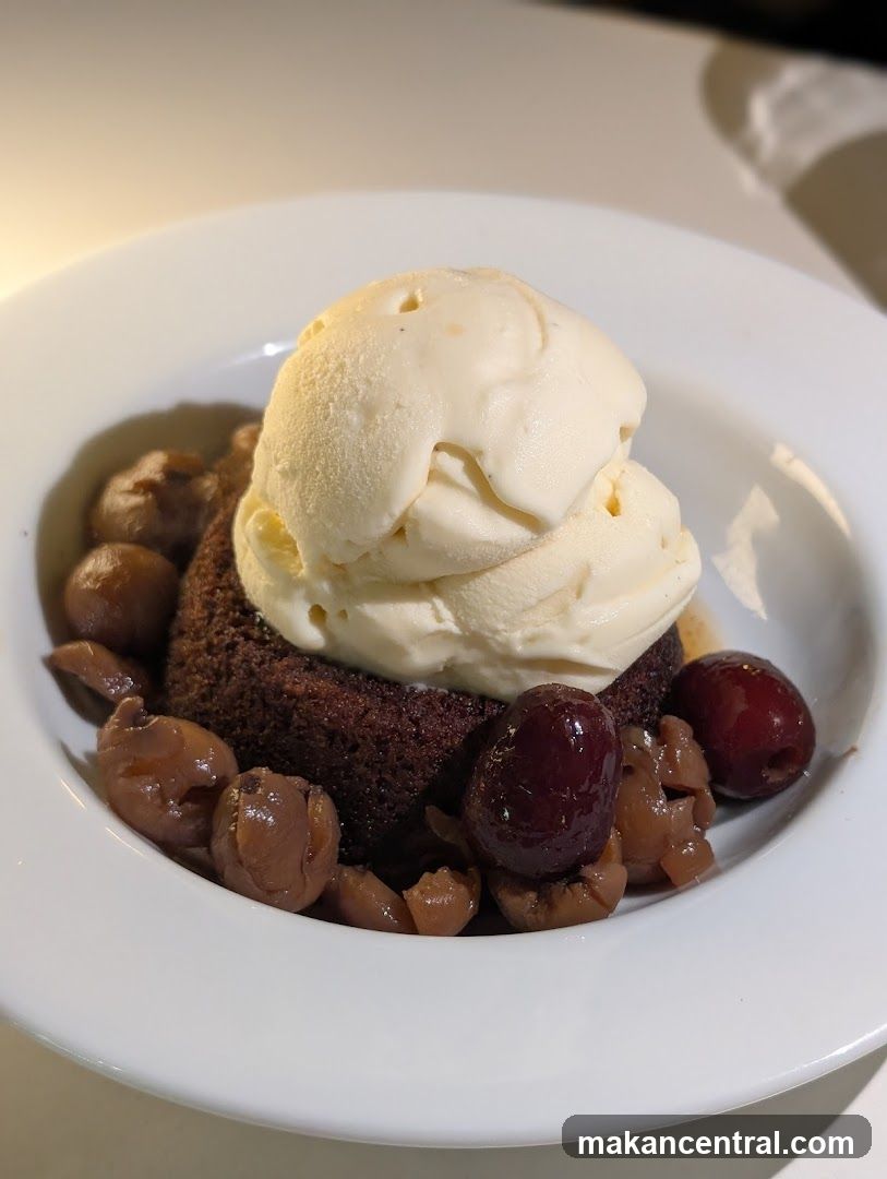 Chocolate cake with ice cream and cherries
