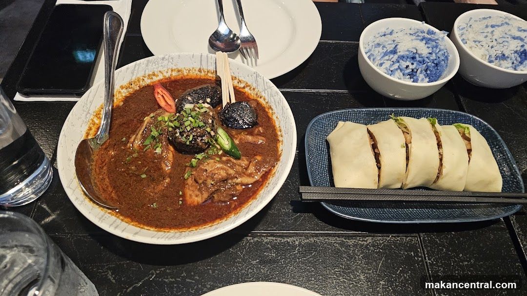 A close-up of a meal with rice and a stew-like dish.