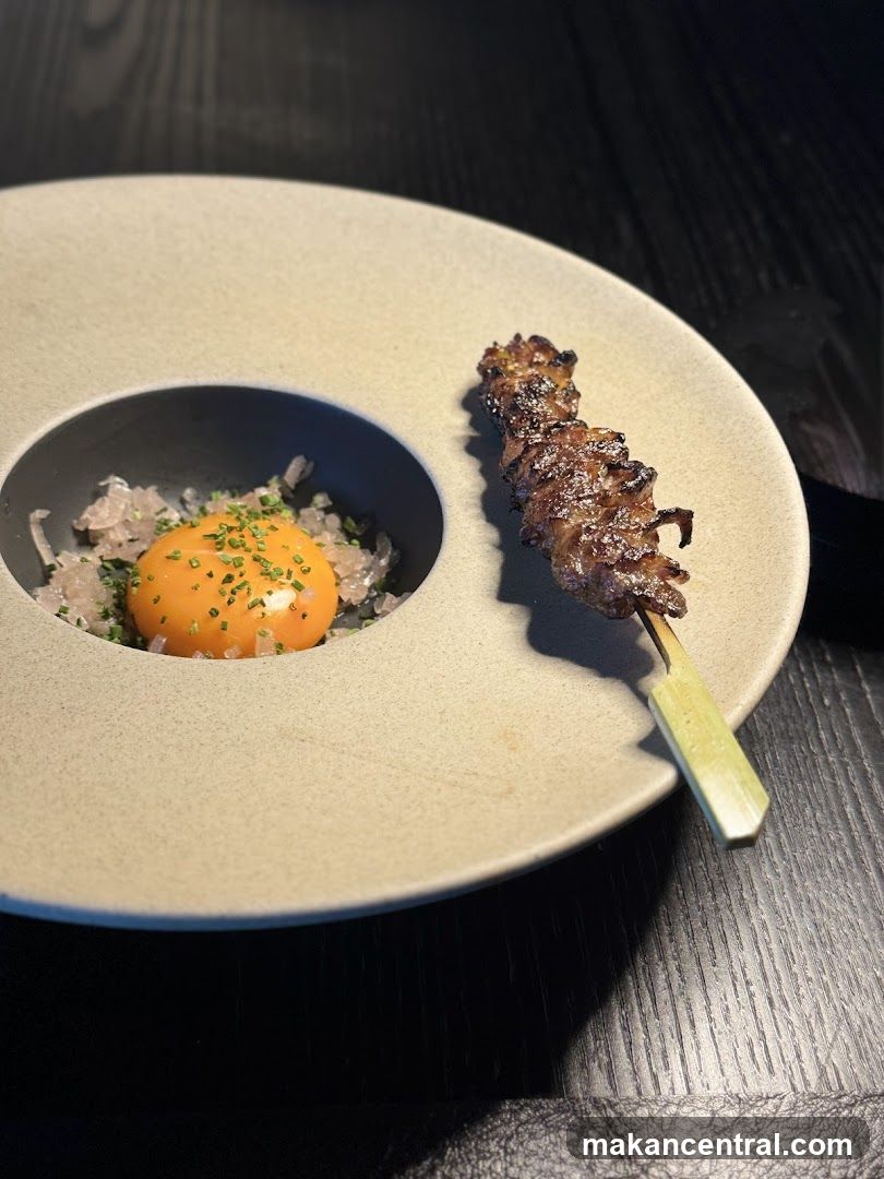 Gourmet Dish with Skewer and Egg Yolk