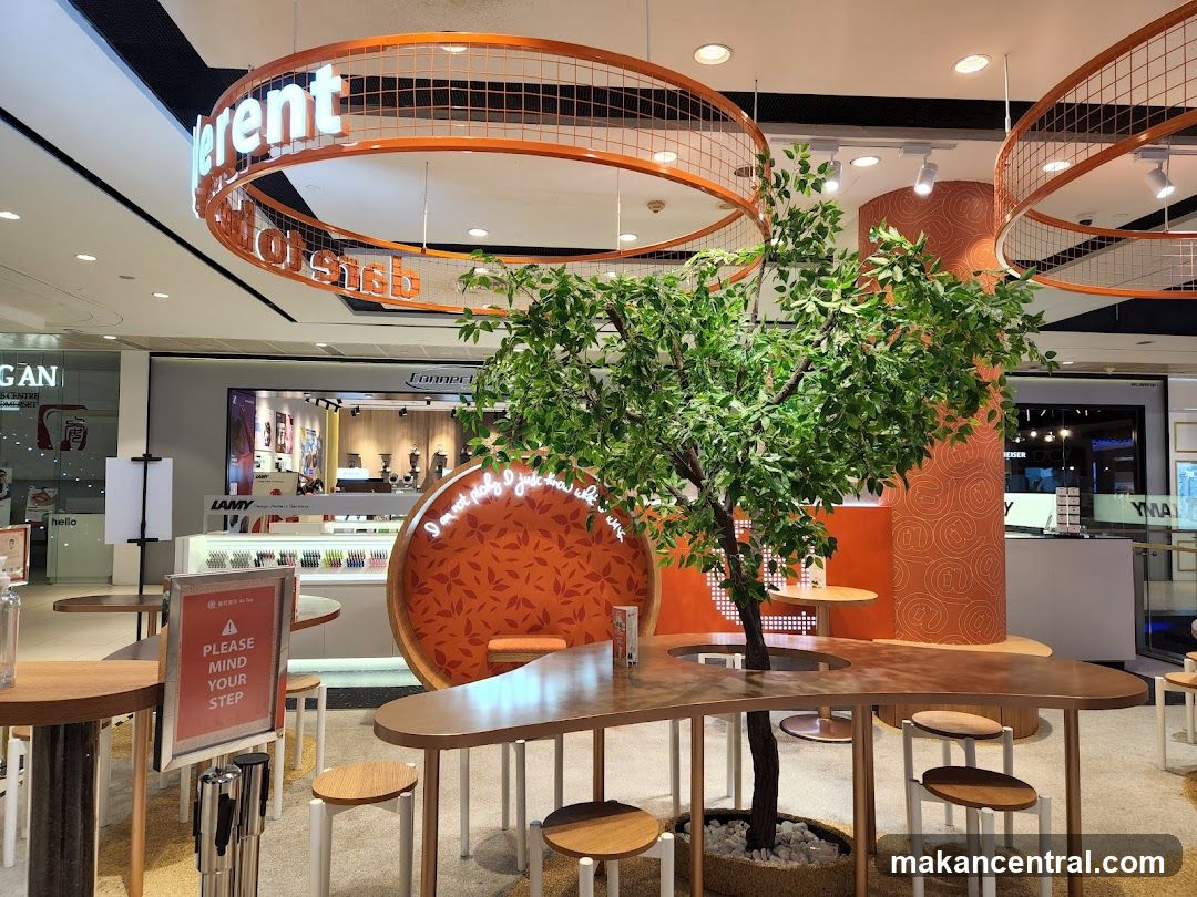 Interior of a store with a tree and seating