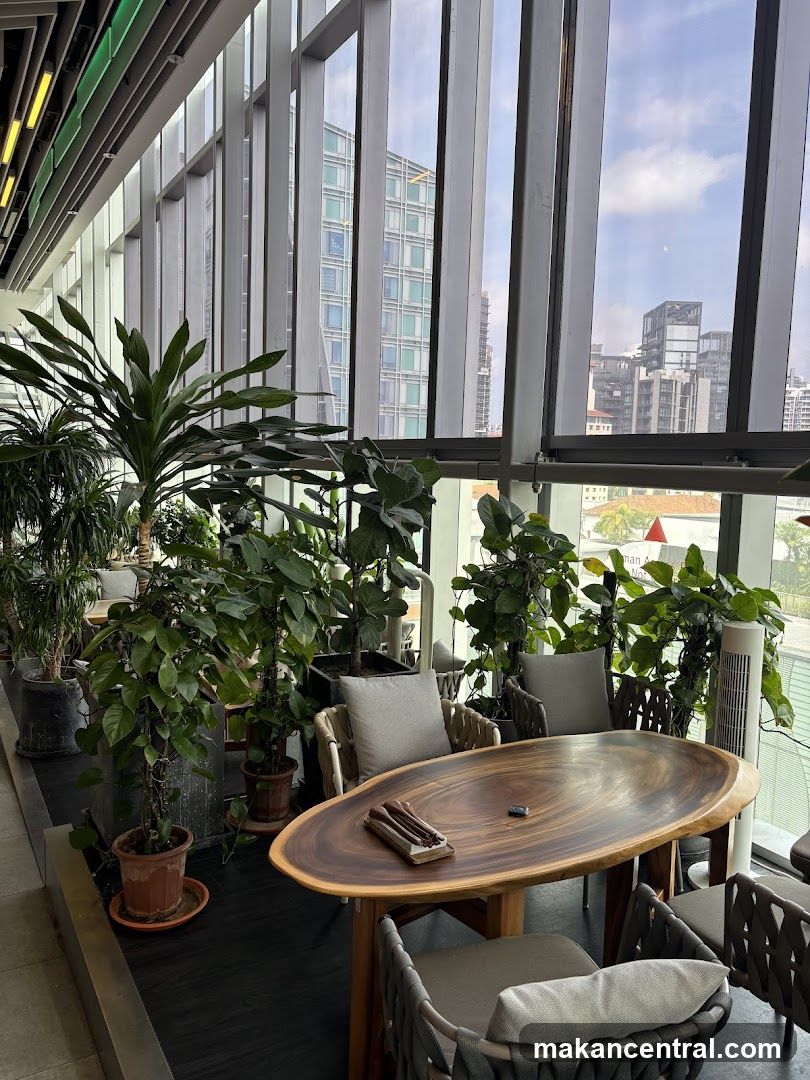 Indoor seating area with plants and city view