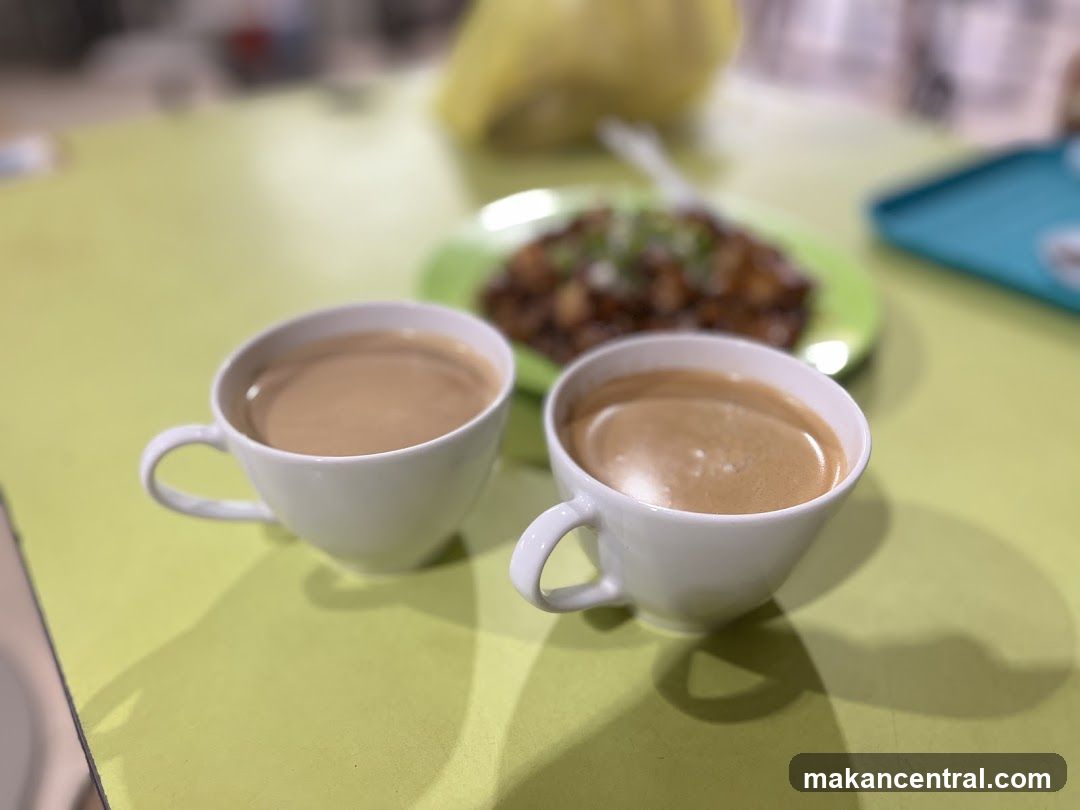 Two cups of coffee and a plate of food