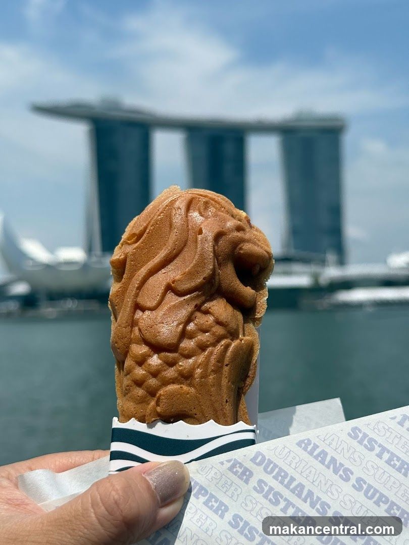 Merlion-shaped pastry with Marina Bay Sands in the background