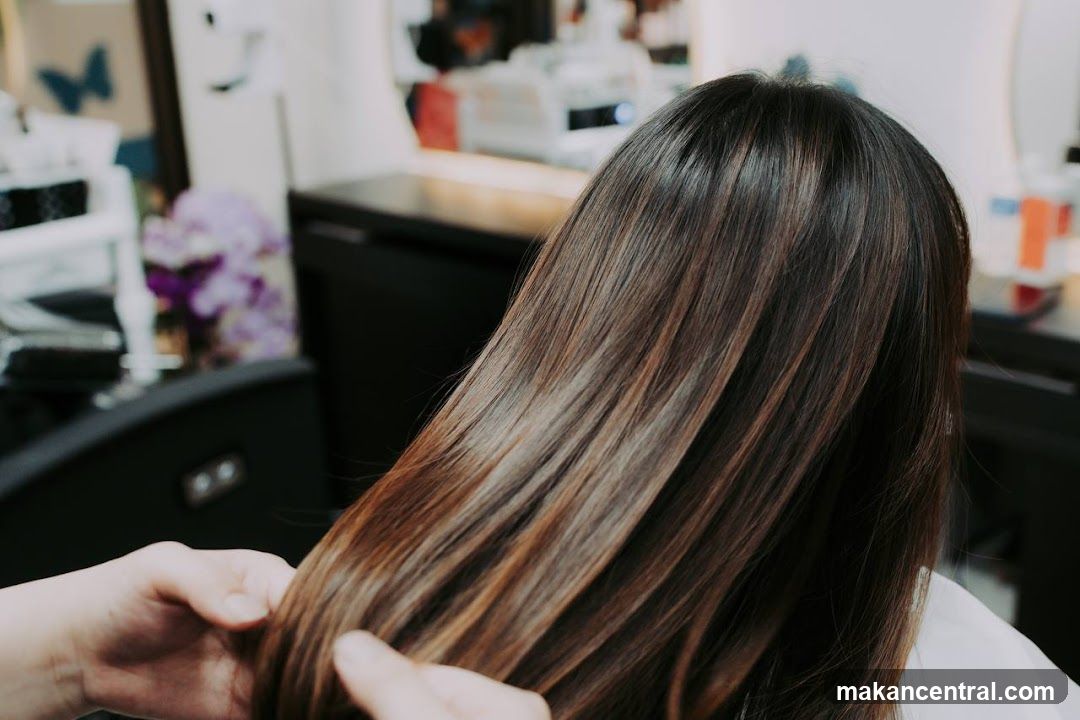 Hairdresser styling client's hair