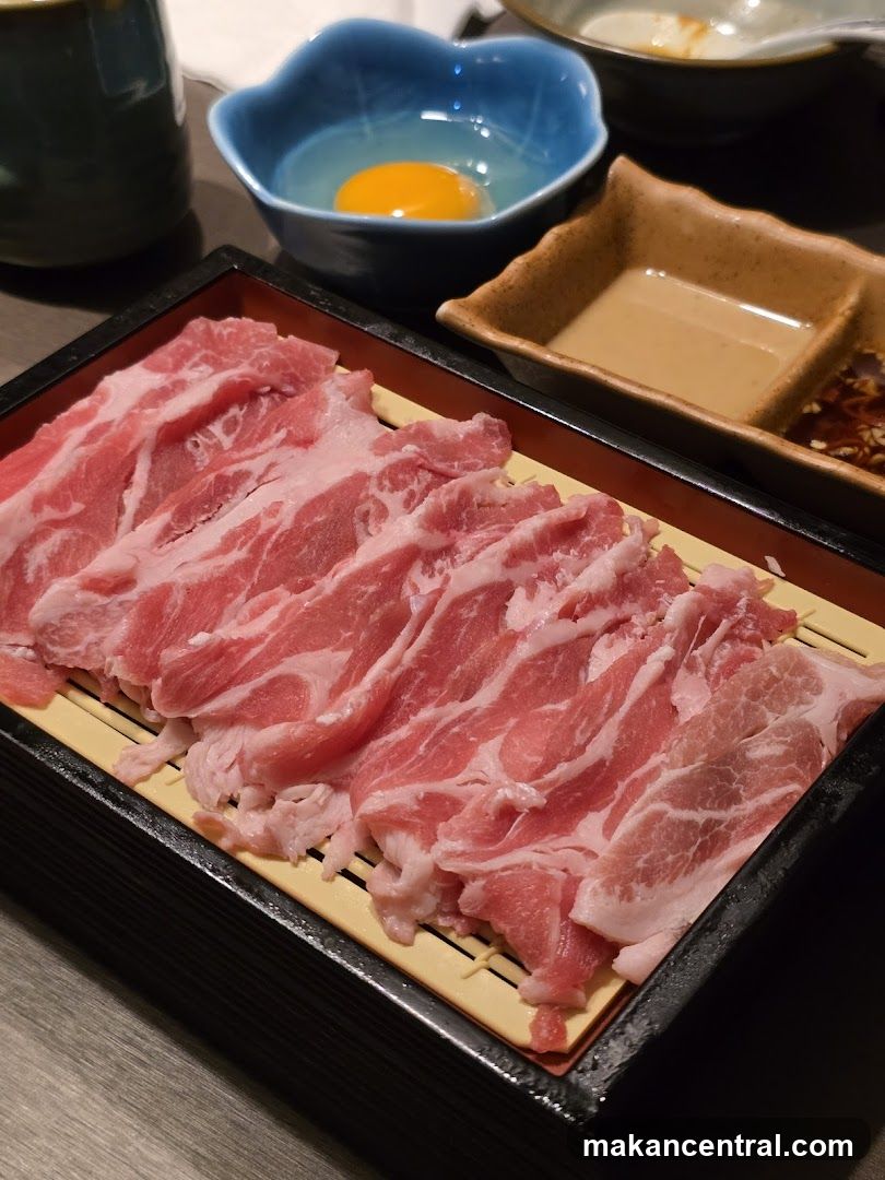 Thinly Sliced Raw Meat with Egg and Sauces