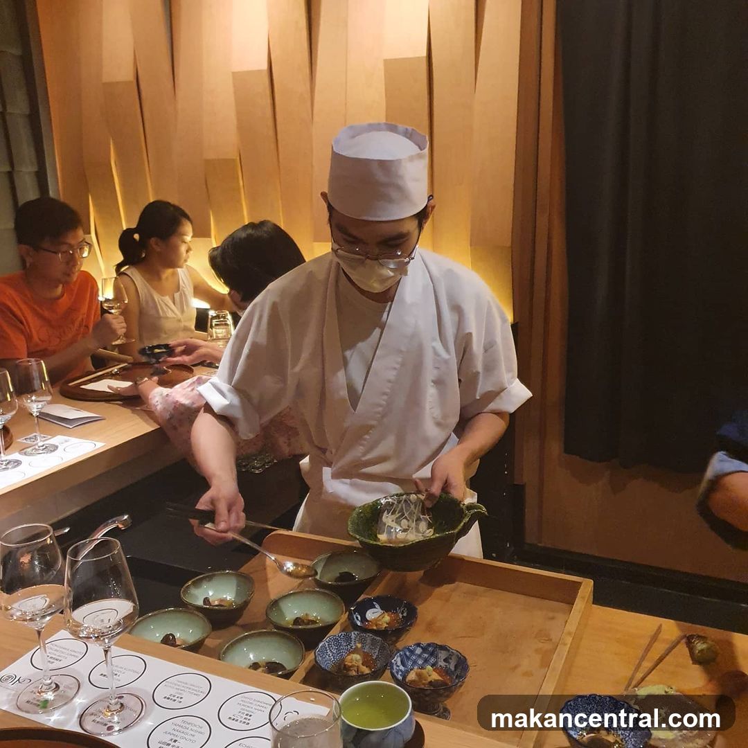 Chef serving food at a counter