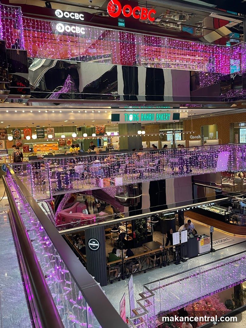 Interior of a shopping mall with various shops and eateries