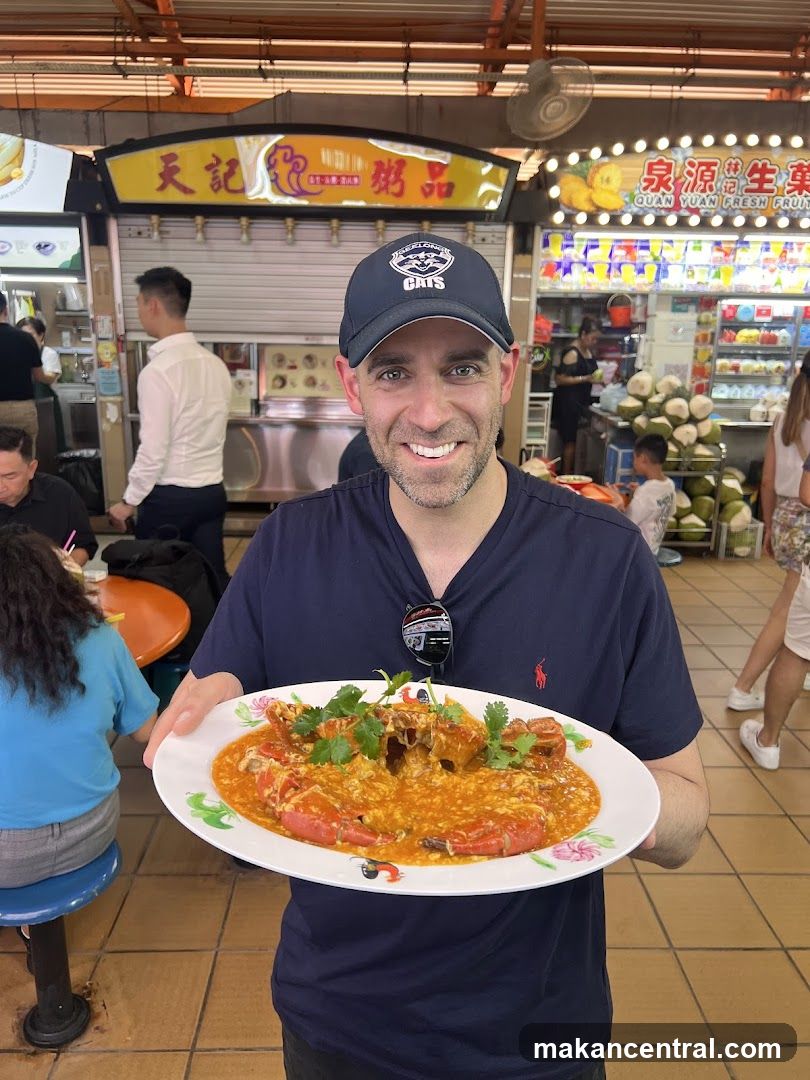 Man holding a plate of chili crab